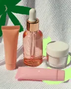Skincare serums and cream tubes arranged on a white textured surface
