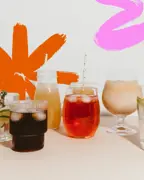 Assorted functional drinks and beverages in glasses on a light surface